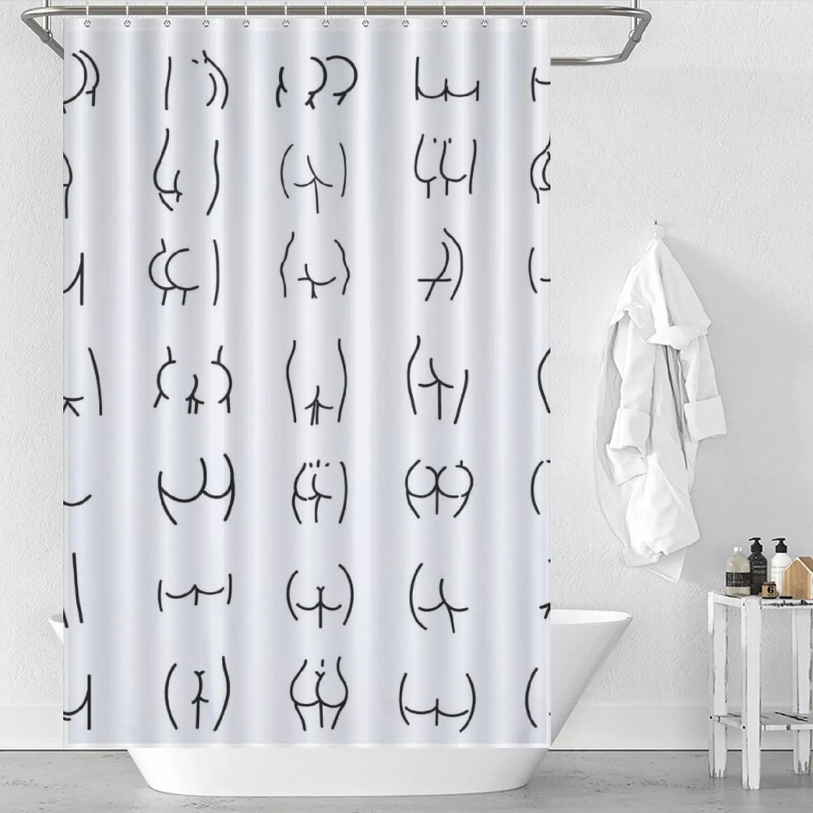 A white shower curtain with black and white drawings on it.