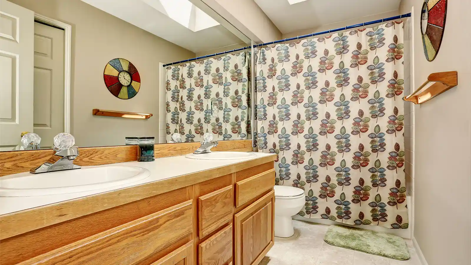 how to keep shower curtain closed？A bathroom with two sinks and a securely closed shower curtain.