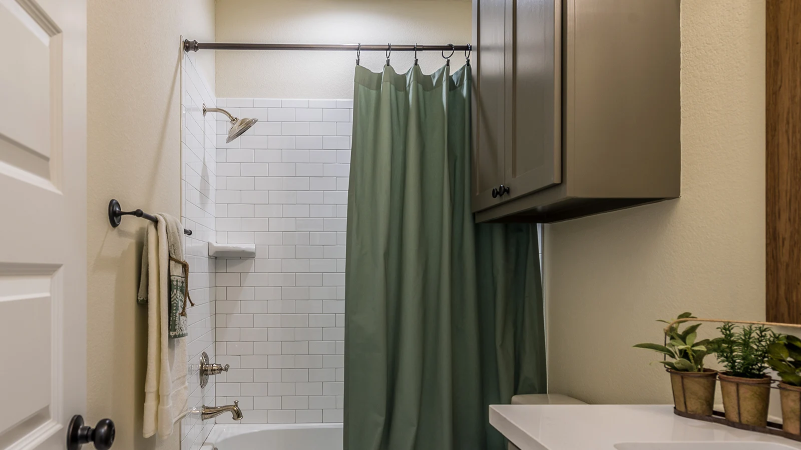 Types of Shower Curtain Hooks: A bathroom with a green shower curtain.